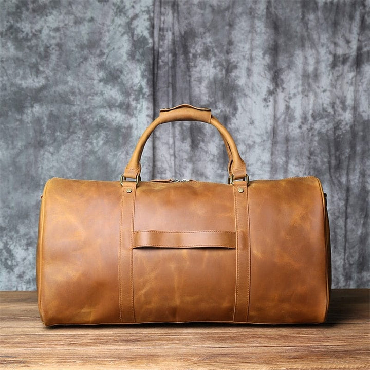 Sac de voyage en cuir de qualité supérieure, vue latérale, montrant les fermetures éclair