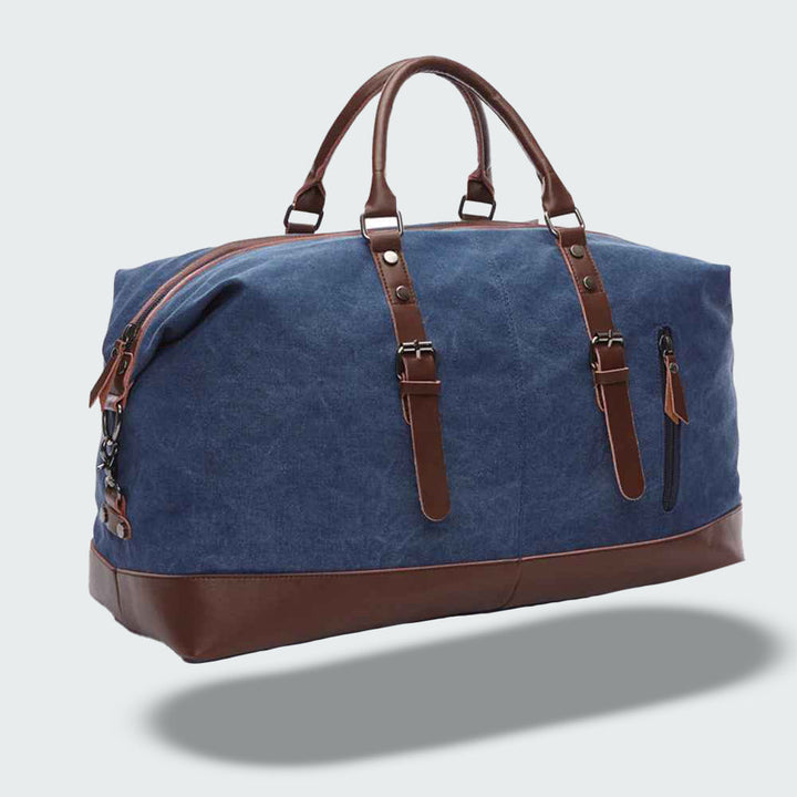 Sac de voyage unisexe en toile cirée, poignées en cuir, pour une escapade ou une aventure.