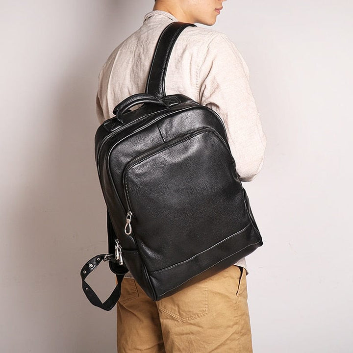 Sac à dos en cuir véritable noir pour homme, élégant et moderne, idéal pour un ordinateur portable.