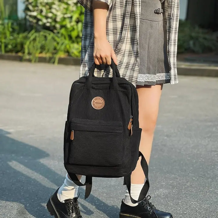 Sac à dos quotidien femme en velours côtelé, idéal pour livres et ordinateur, élégant et fonctionnel.