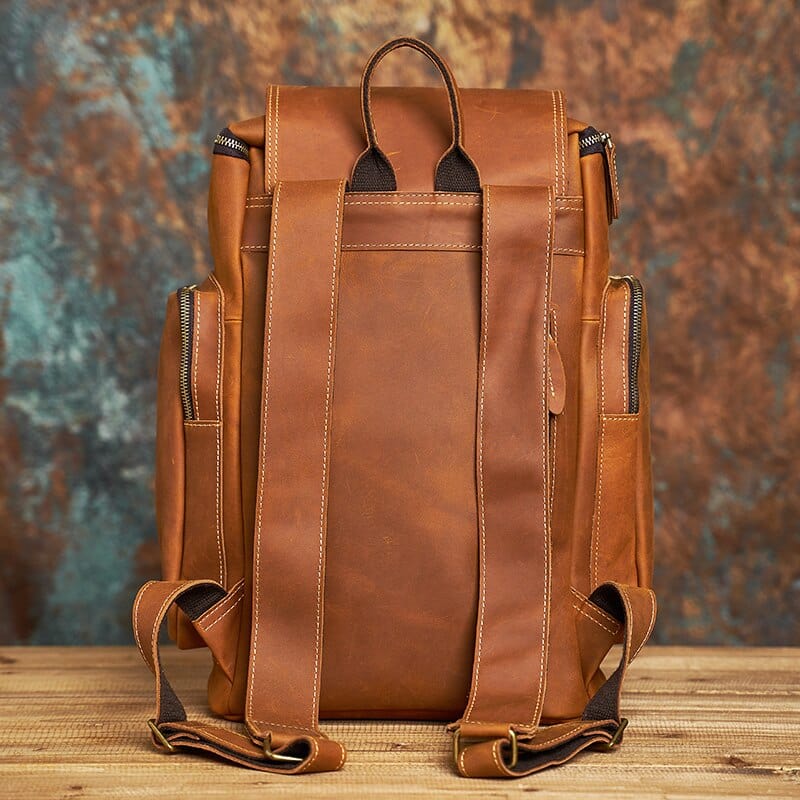Détail des sangles ajustables d'un sac à dos homme en cuir, pour un confort optimal.