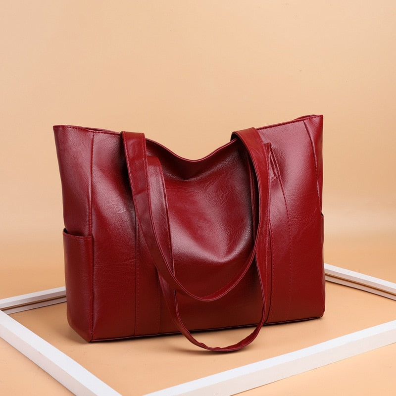 Sac à main cabas en cuir PU rouge audacieux pour femme, élégant et polyvalent, accessoire de mode quotidien.