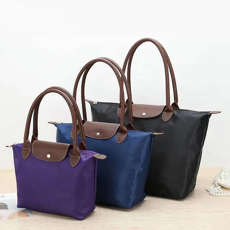 Sac à main femme vert armée spacieux avec anses, idéal pour une touche chic et tendance.