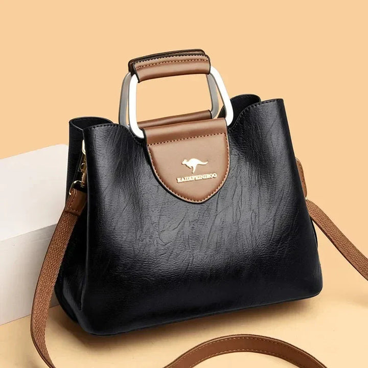 Sac à main en cuir noir structuré pour femme, élégant et pratique au quotidien.