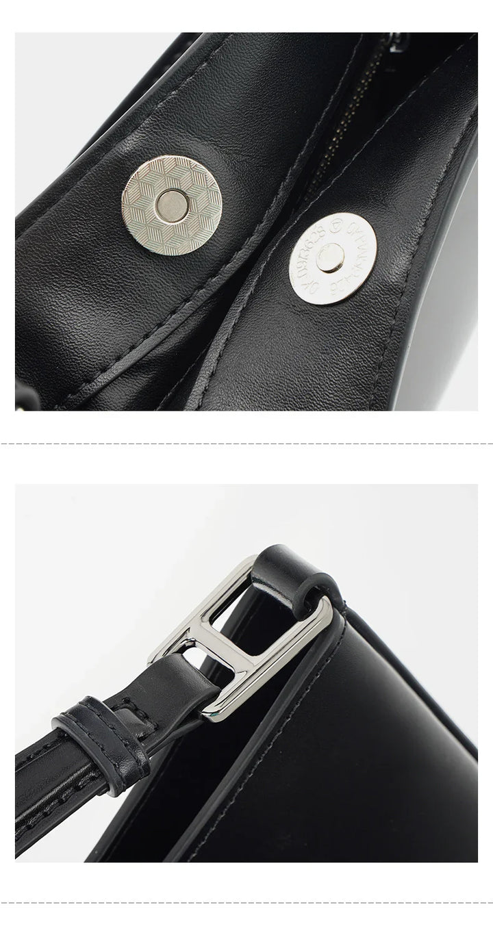 Accessoire mode sac femme en cuir noir, détail logo discret, bandoulière réglable, finition impeccable.