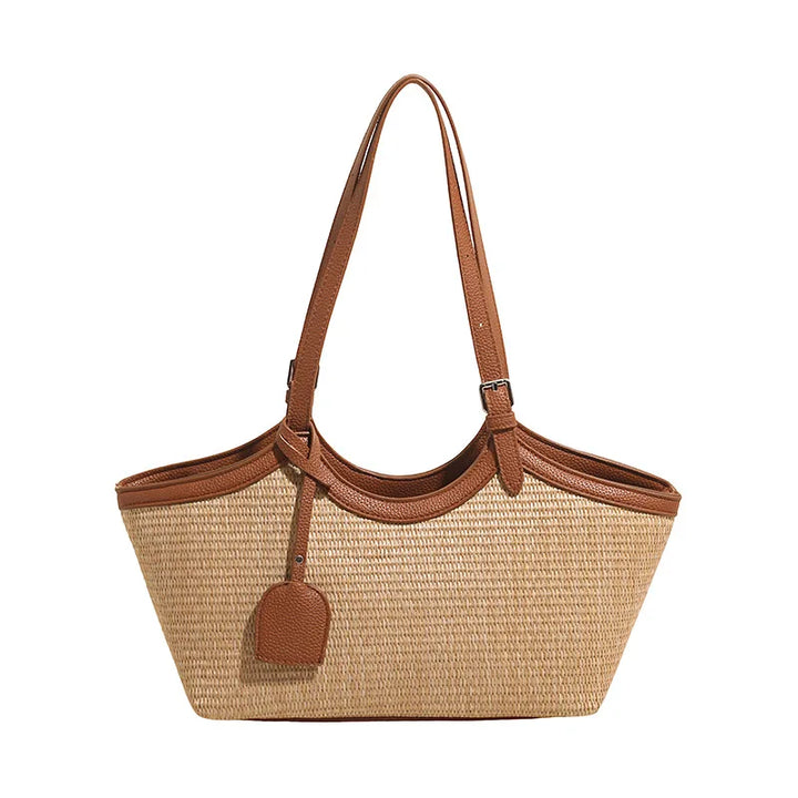 Sac de mode femme, paille et similicuir, un cabas chic pour l'été et les journées ensoleillées.
