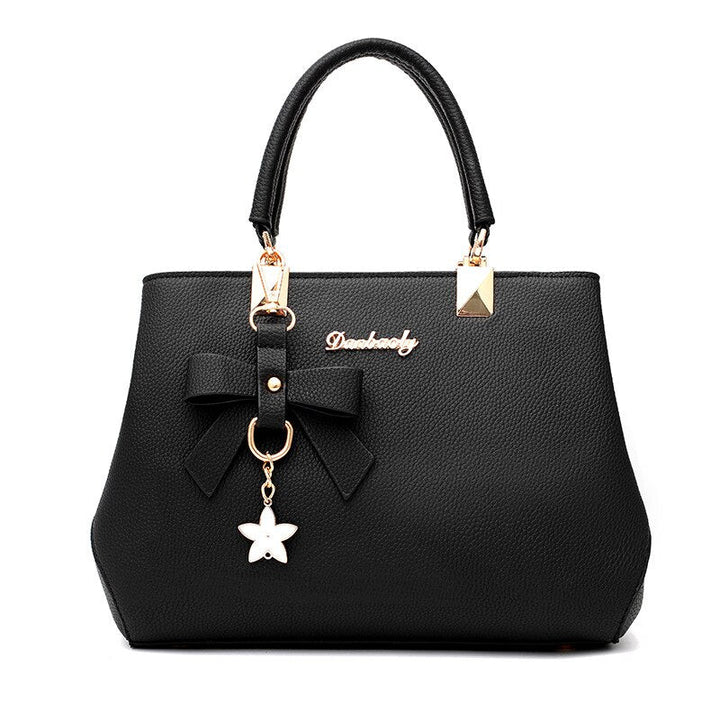 Sac à main femme élégant en similicuir noir avec bandoulière, idéal pour le quotidien.