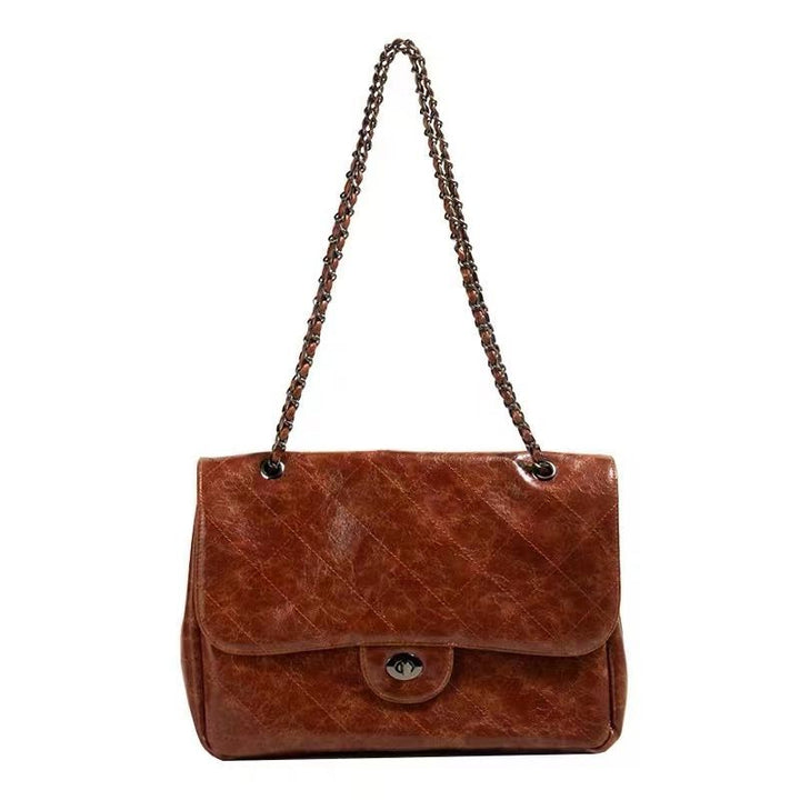 Sac épaule marron femme tendance en simili cuir, anse chaîne et bandoulière amovible. Style chic et moderne.