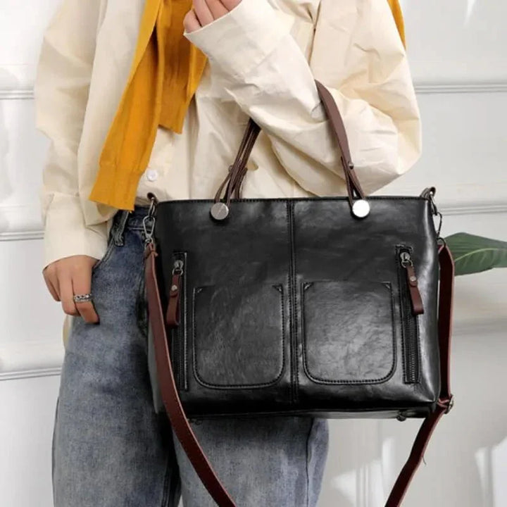 Sac à main noir chic pour femme, polyvalent, accessoire de mode intemporel et essentiel.