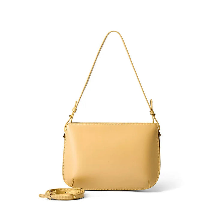 Gros plan d'un sac à main luxe en cuir véritable noir, détaillant la texture riche et les coutures fines.