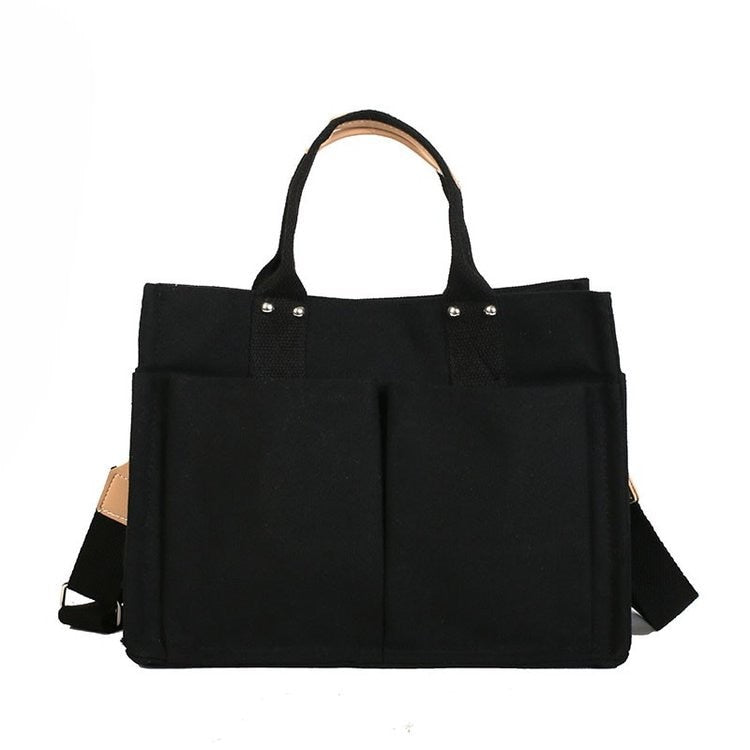 Sac à main noir moderne et spacieux, accessoire de mode pour étudiant, idéal pour transporter des affaires scolaires