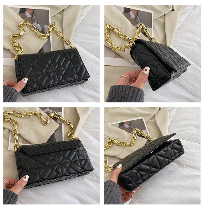 Sac à main noir bandoulière avec détails dorés, accessoire mode chic pour femme.