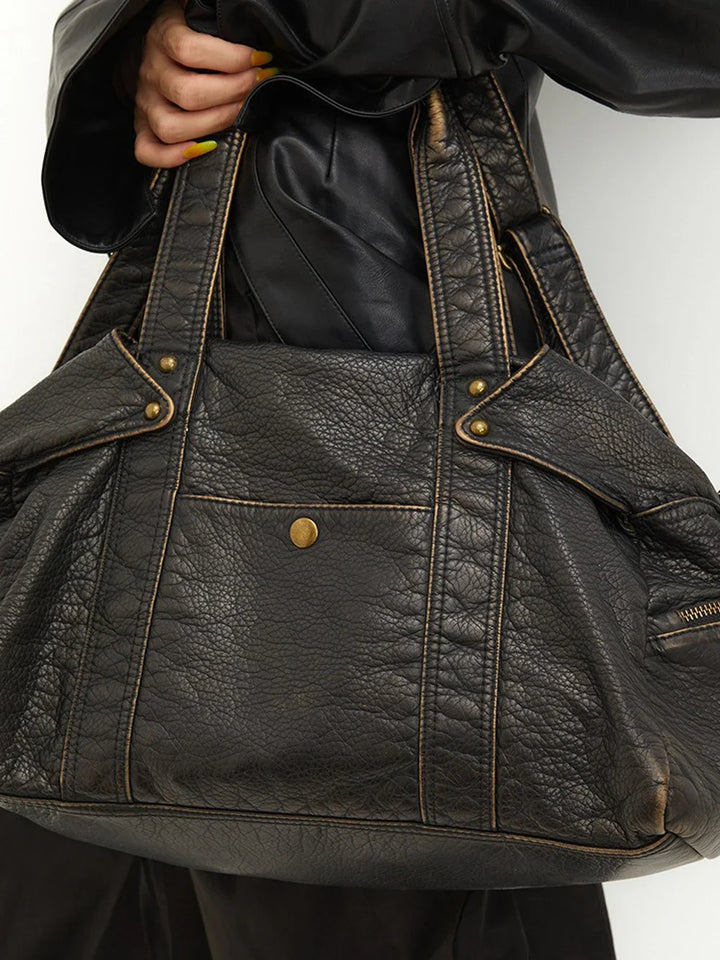 Sac à main femme noir en cuir synthétique. Élégant, grand et pratique. Idéal pour étudiante, mode ou travail.