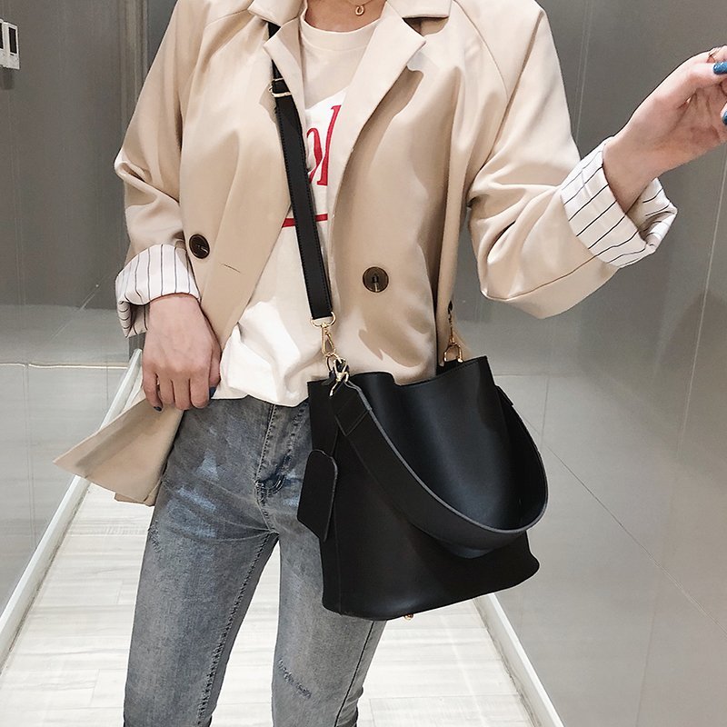 Sac cabas noir pour femme, grand format, avec bandoulière ajustable, idéal pour un look chic et quotidien.