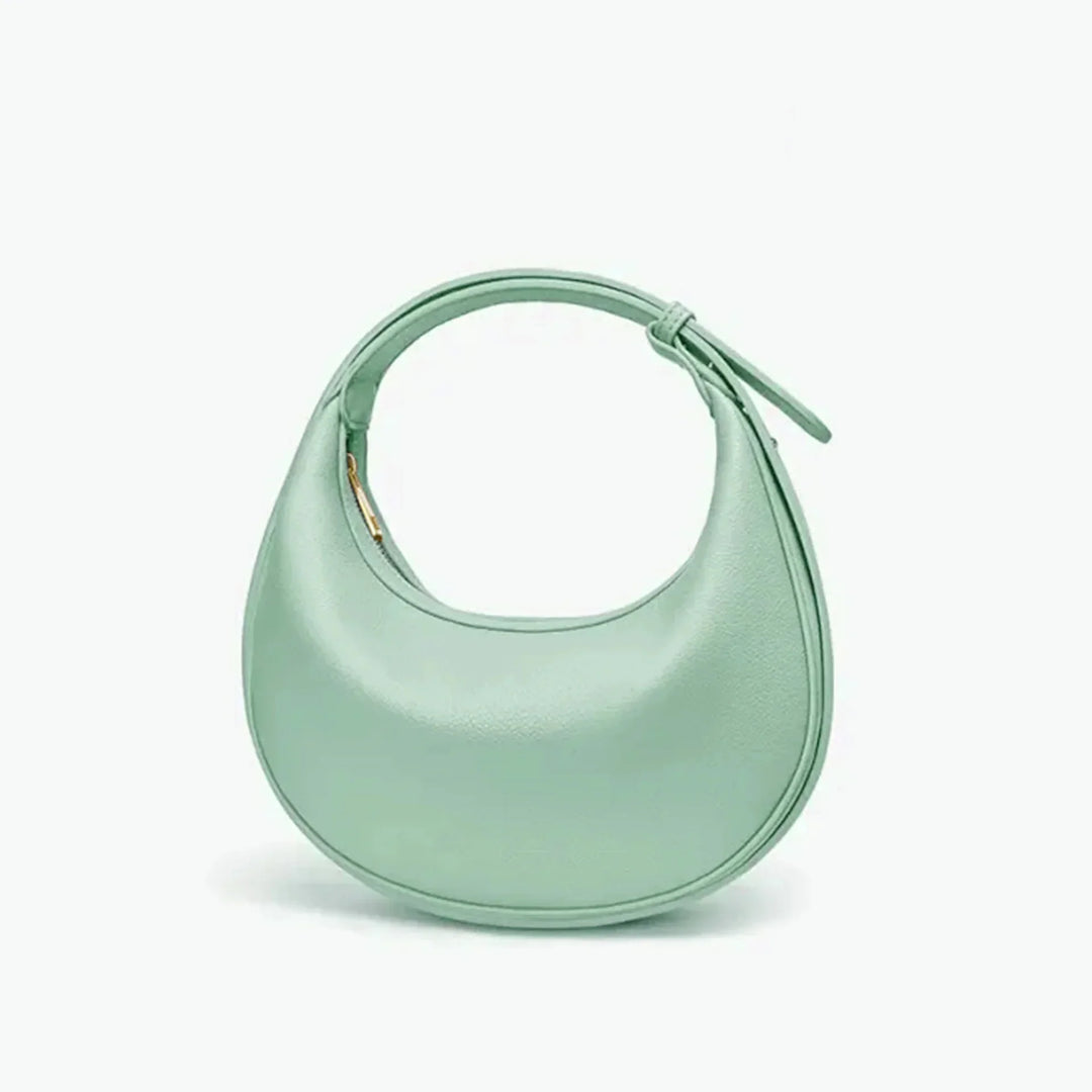Sac à main rond pour femme en éco-cuir, design élégant et moderne.
