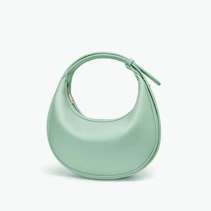 Sac à main rond pour femme en éco-cuir, design élégant et moderne.