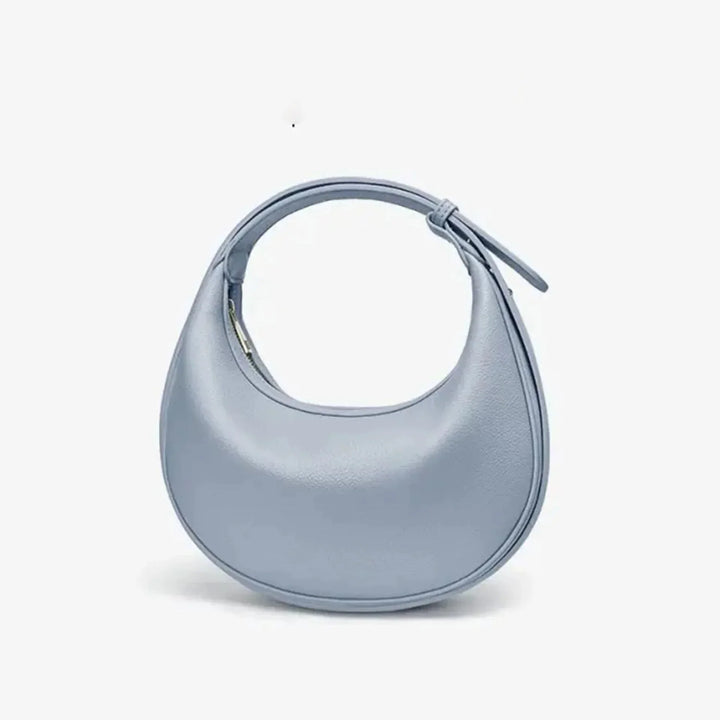 Sac bandoulière rond polyvalent pour femme, pratique et élégant, disponible en plusieurs coloris.