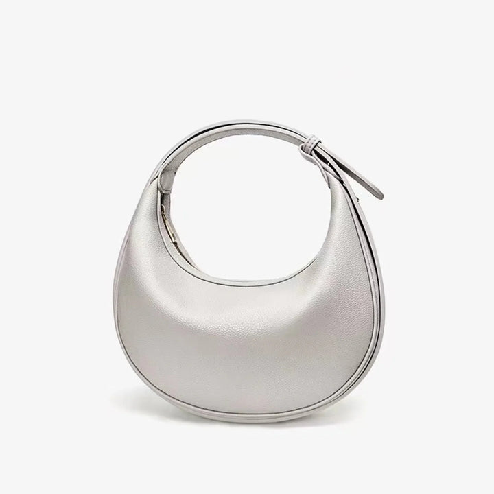 Sac à main rond femme beige en éco-cuir, idéal pour une tenue décontractée chic.