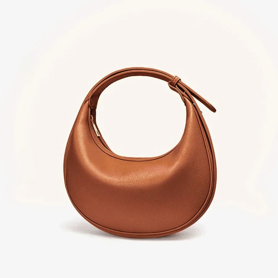 Sac bandoulière rond vert pour femme, style unique, fait d'éco-cuir durable.