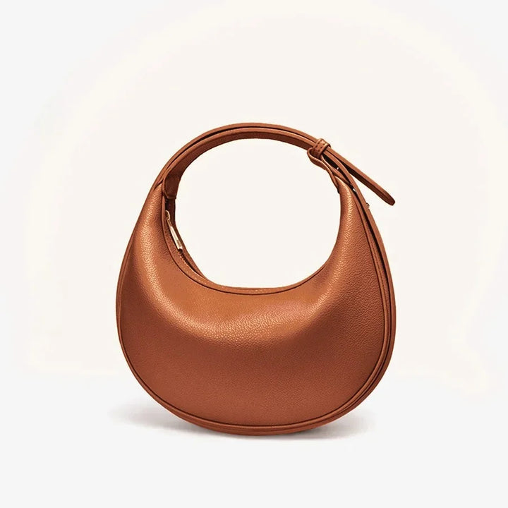 Sac bandoulière rond vert pour femme, style unique, fait d'éco-cuir durable.