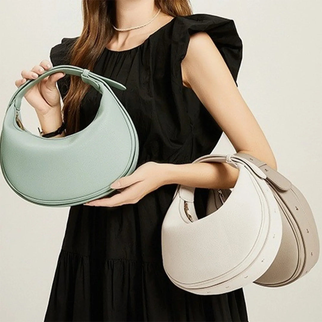 Sac à main rond noir pour femme, design unique en éco-cuir tendance.