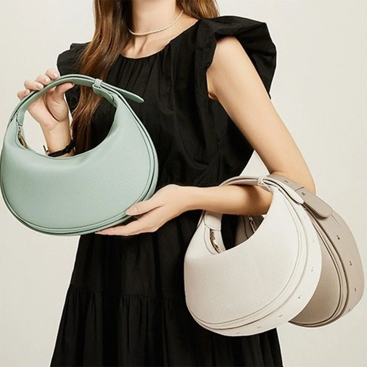 Sac à main rond noir pour femme, design unique en éco-cuir tendance.