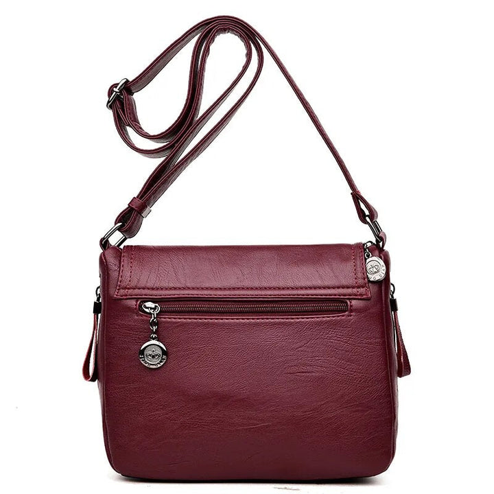 Besace élégante femme en similicuir, avec bandoulière ajustable, pour un style décontracté chic.