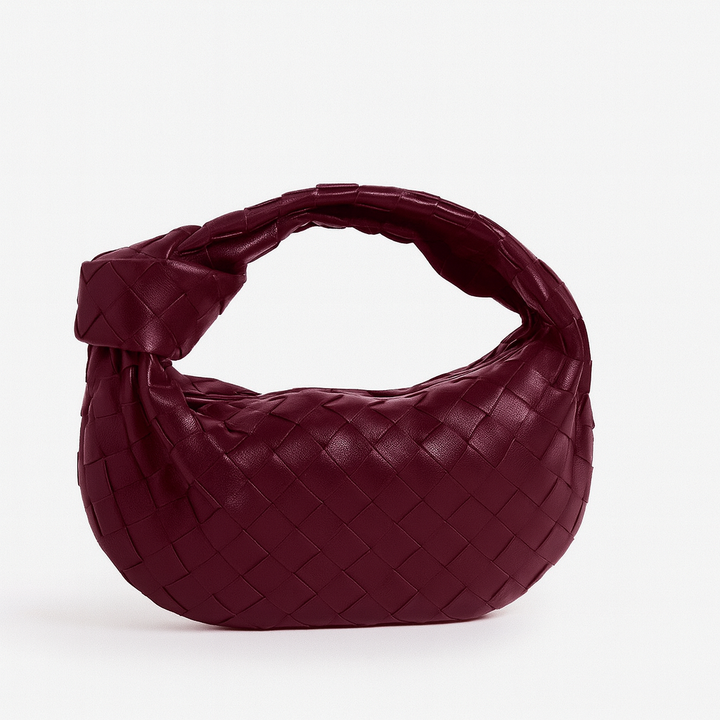 Texture du sac à main femme tissé en cuir synthétique. Un accessoire mode élégant et chic.