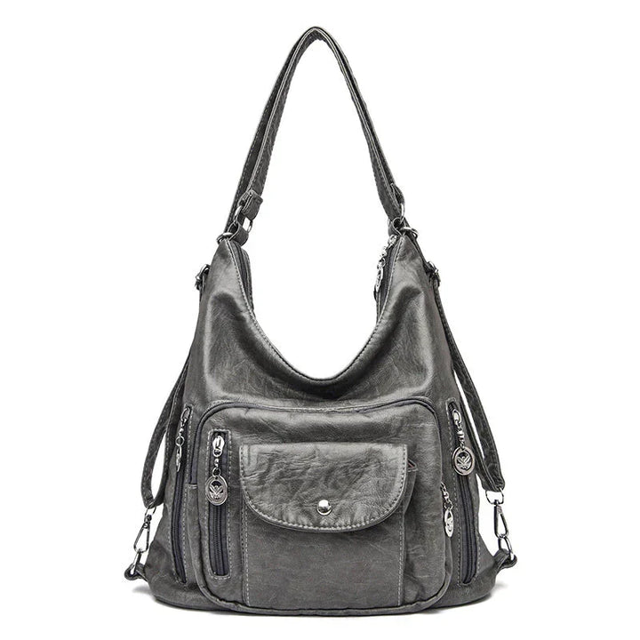 Sac à main femme compact en cuir souple, grande capacité, multipoches discrètes pour organiser.