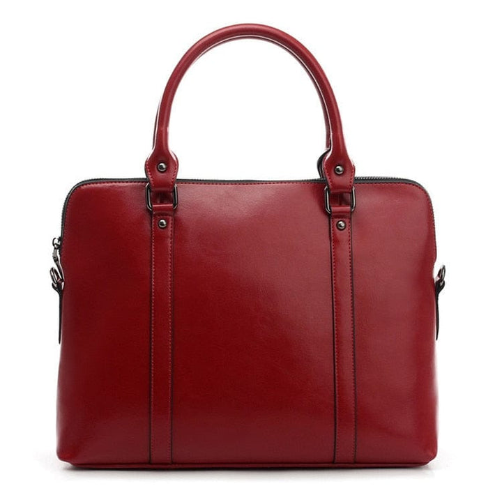 Sac pour PC portable femme en cuir véritable, couleur cognac, lignes épurées et professionnelles.