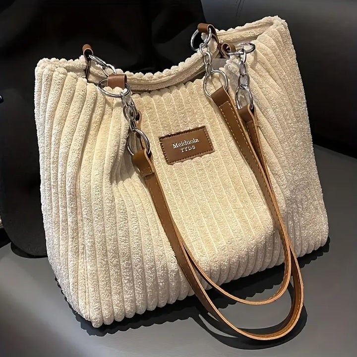Accessoire mode femme: sac shopper élégant en velours côtelé, sac à main chic de grande capacité.