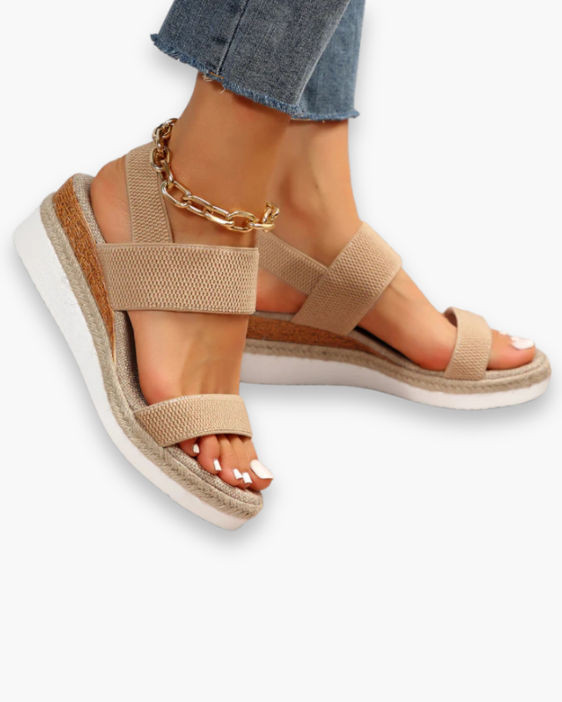 Sandales compensées femme élégantes, talon robuste, bride ajustable, design moderne, confort toute la journée.