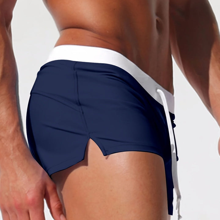 "Short de bain homme bleu marine, taille élastique, design sportif et moderne pour plage et piscine."