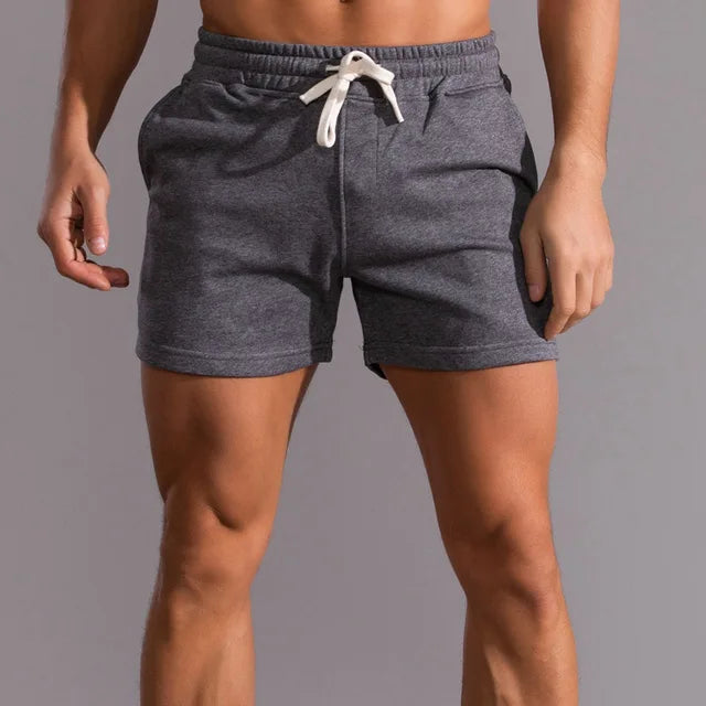 "Short homme été Lucien en coton, style décontracté élégant, couleurs variées, coupe ample et cordon ajustable."