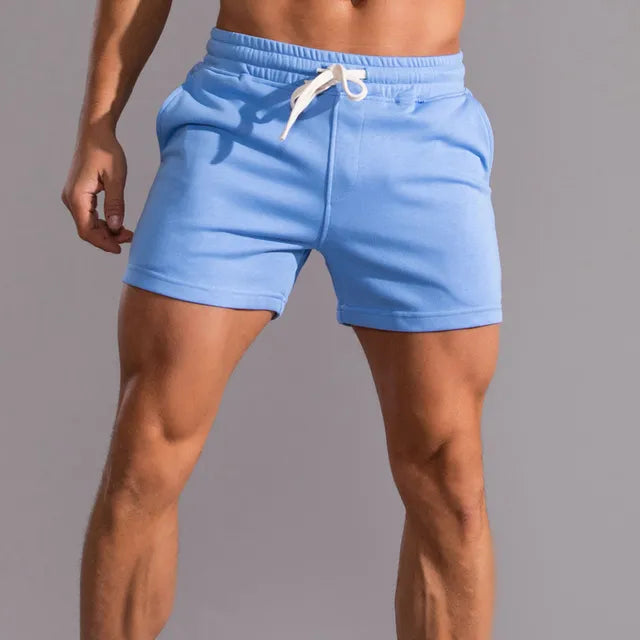 "Short homme été Lucien en coton, style décontracté élégant, couleurs variées, coupe ample et cordon ajustable."