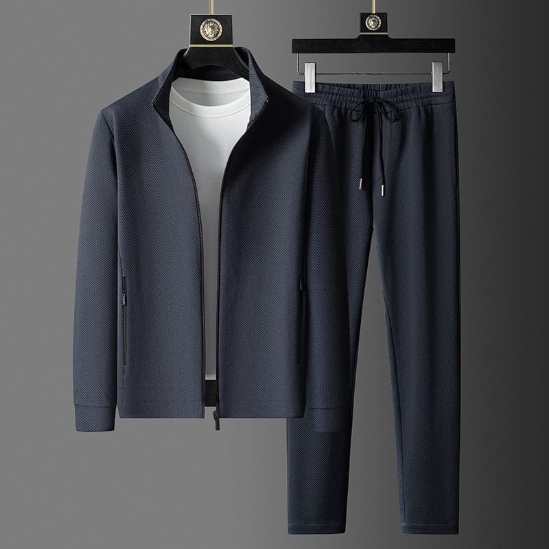 Ensemble survêtement homme bleu foncé, coupe ajustée, veste zippée confort pour sport et look décontracté.