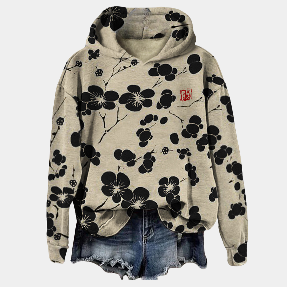 Pull long femme fleuri Kaori avec capuche, motif floral unique. Parfait pour un confort mi-saison.