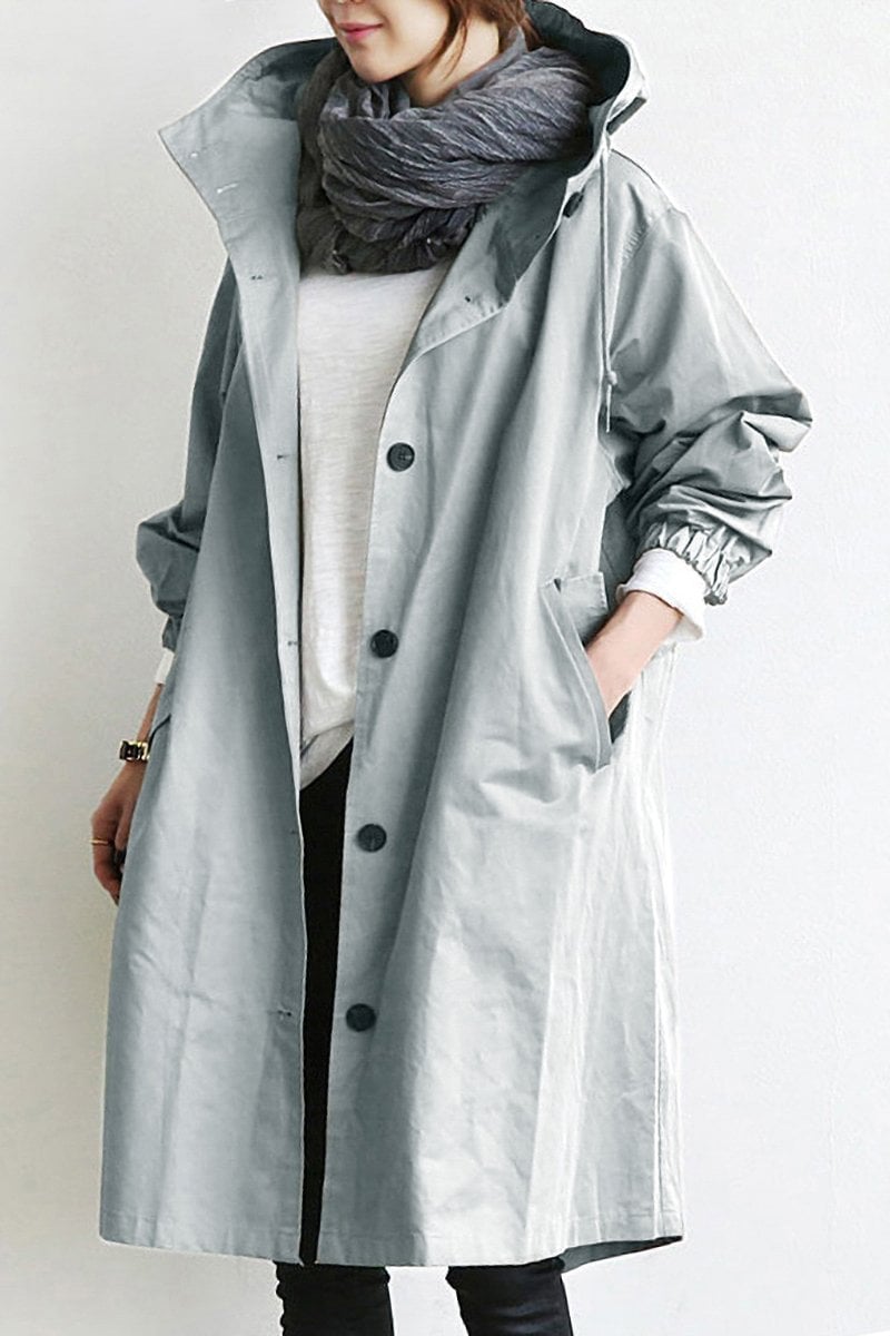 Trench imperméable élégant, coupe flatteuse, capuche.  Parfait pour l'automne et l'hiver.