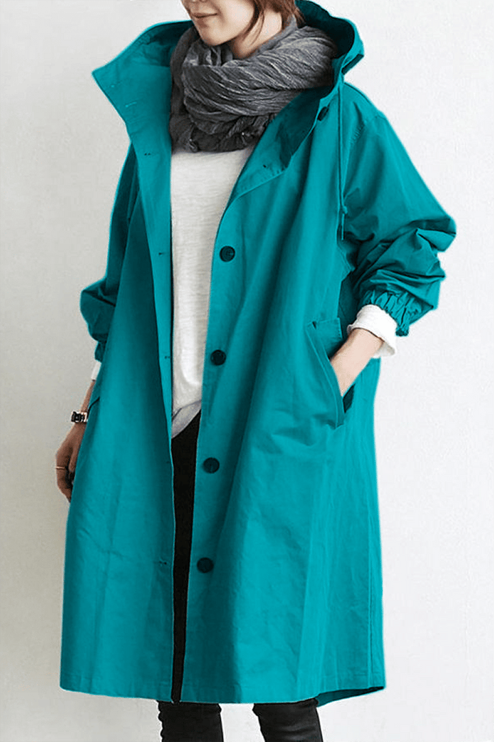 Trench imperméable élégant, coupe flatteuse, capuche.  Parfait pour l'automne et l'hiver.
