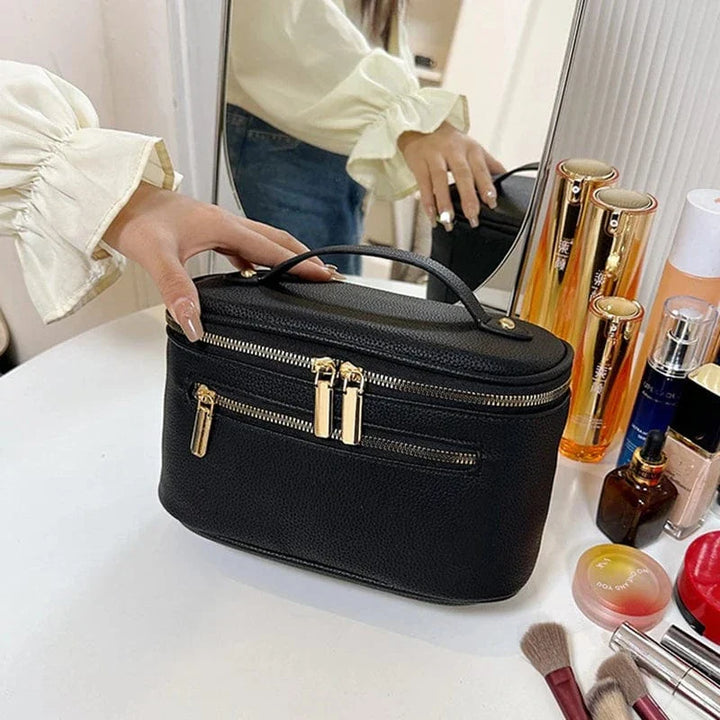 Trousse de maquillage femme en cuir PU noir, ouverte, montrant l'intérieur spacieux et doublé