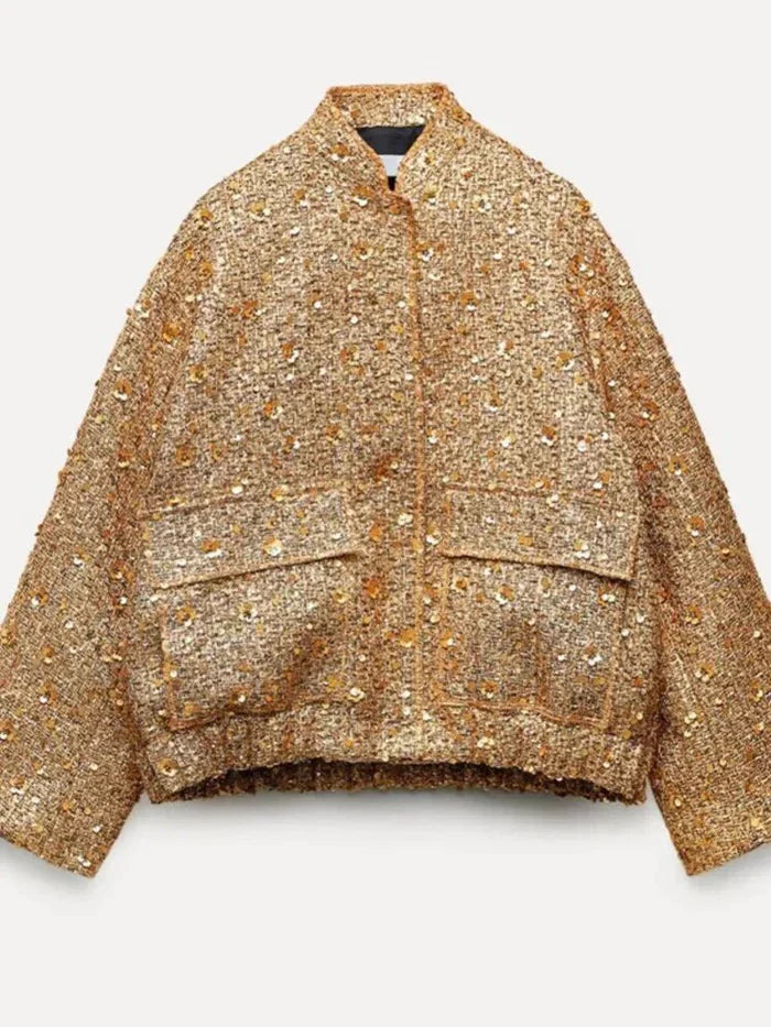 "Veste femme dorée à paillettes brillante, coupe flatteuse et moderne, idéale pour soirées glamour et occasions spéciales."