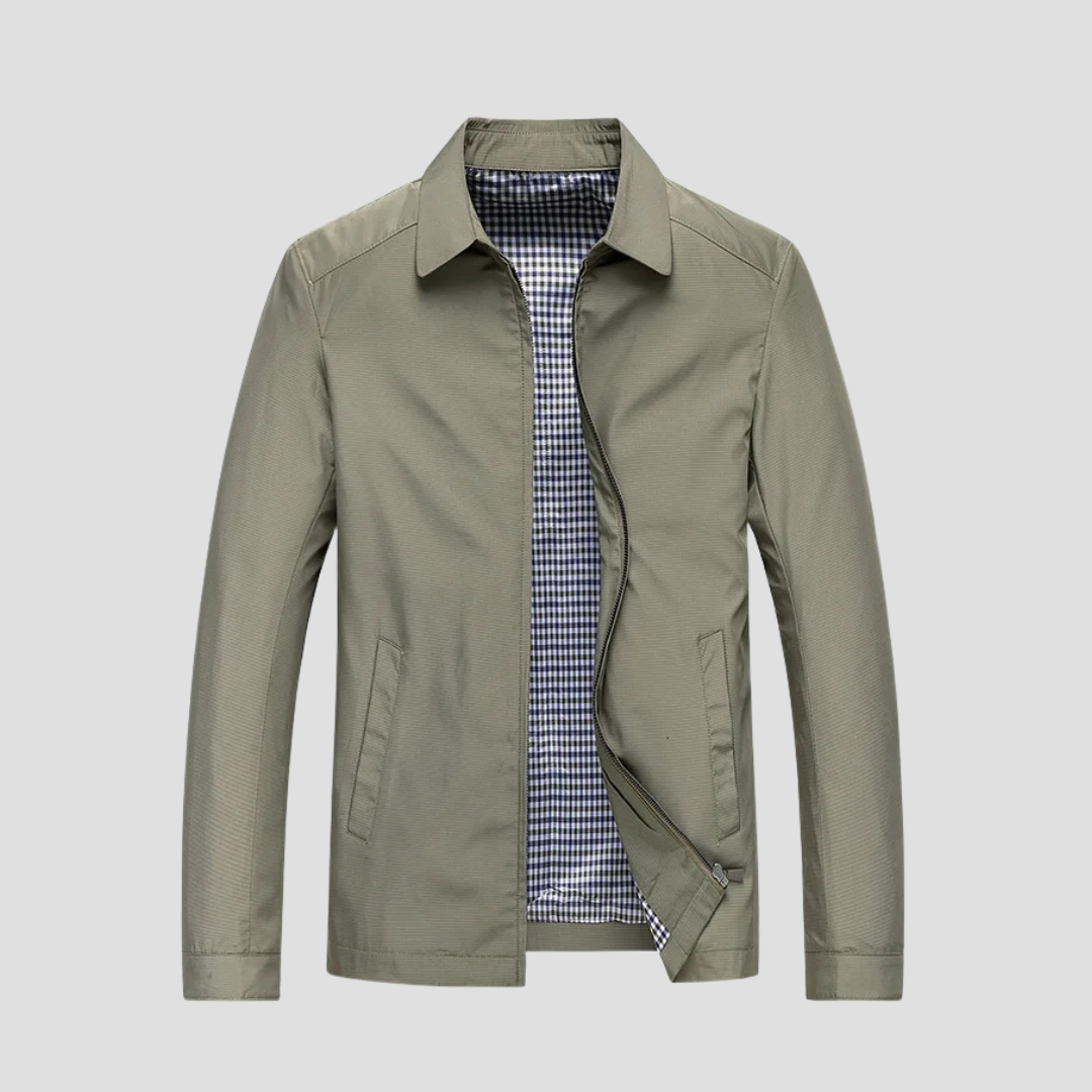 "Veste zippée imperméable homme, style urbain, couleur marine, col pointu, doublure à carreaux, fermetures discrètes."