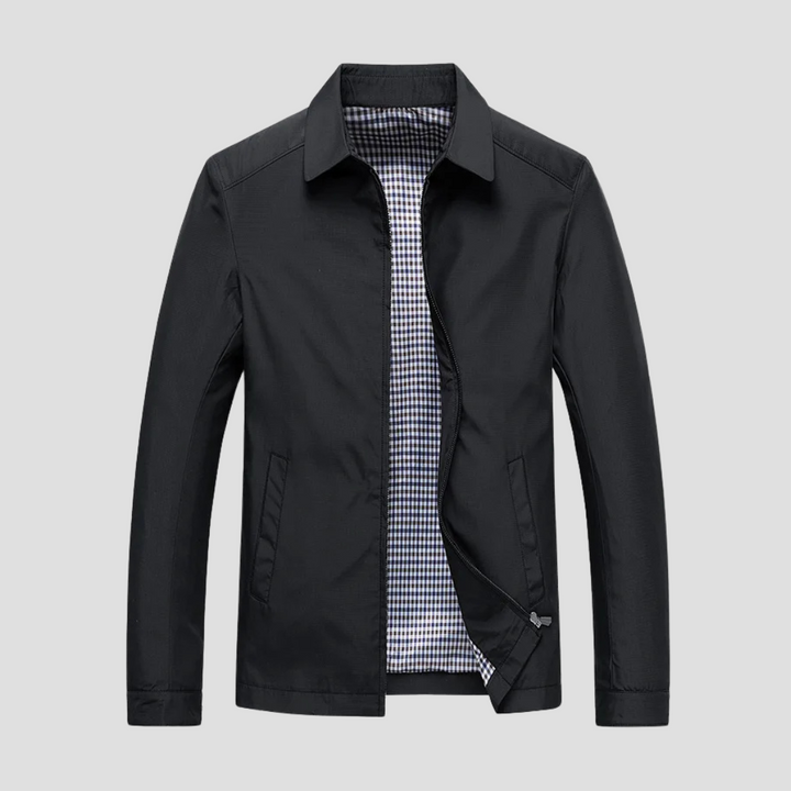 "Veste zippée imperméable homme, style urbain, couleur marine, col pointu, doublure à carreaux, fermetures discrètes."