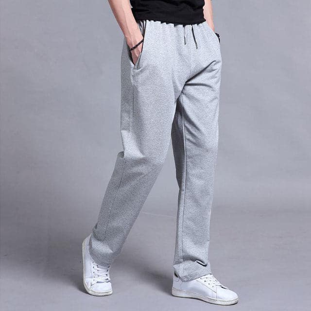 "Vue avant pantalon fuselé noir pour homme, design élégant et moderne, confort optimal, poches zippées, coupe ajustée"