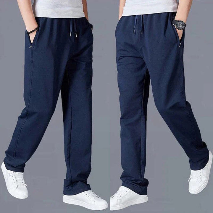 "Vue avant pantalon fuselé noir pour homme, design élégant et moderne, confort optimal, poches zippées, coupe ajustée"