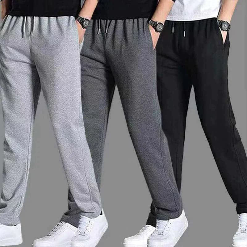 "Vue avant pantalon fuselé noir pour homme, design élégant et moderne, confort optimal, poches zippées, coupe ajustée"