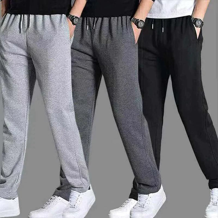 "Vue avant pantalon fuselé noir pour homme, design élégant et moderne, confort optimal, poches zippées, coupe ajustée"